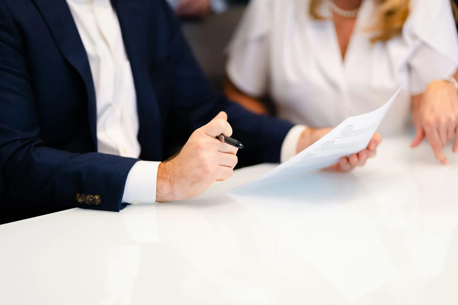 A lawyer going through a document with a client at a table